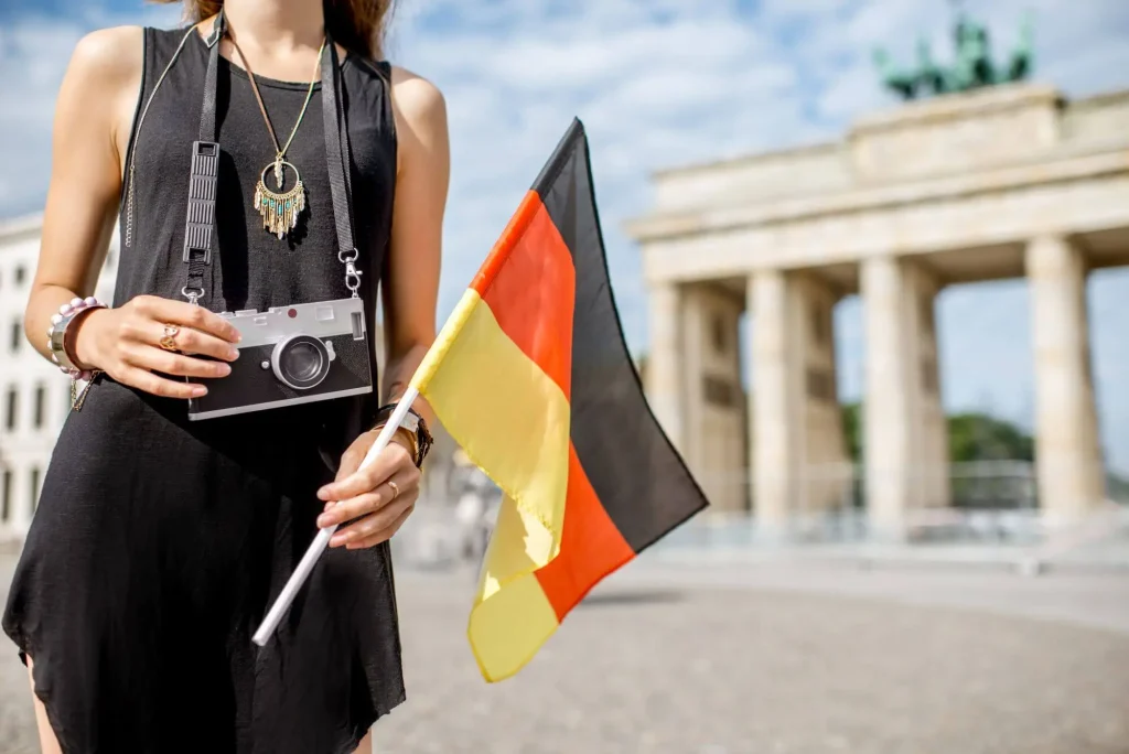 Frau mit deutscher Flagge am Brandenburger Tor
