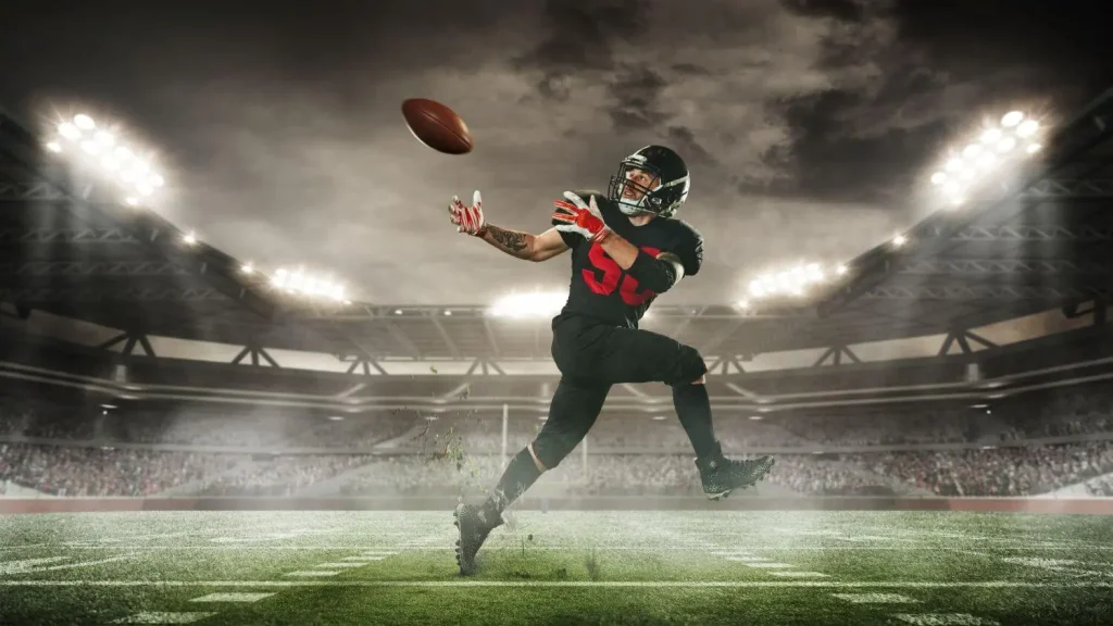 Footballspieler bekommt einen Pass und fängt den Ball